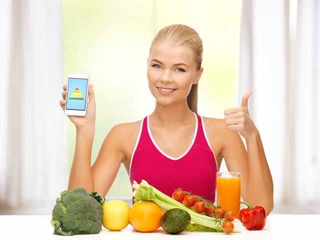 woman with fruits, vegetables and smartphone